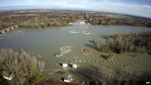 A house is surrounded by water during floods near Vigevano, northern Italy, on 16 November 2014