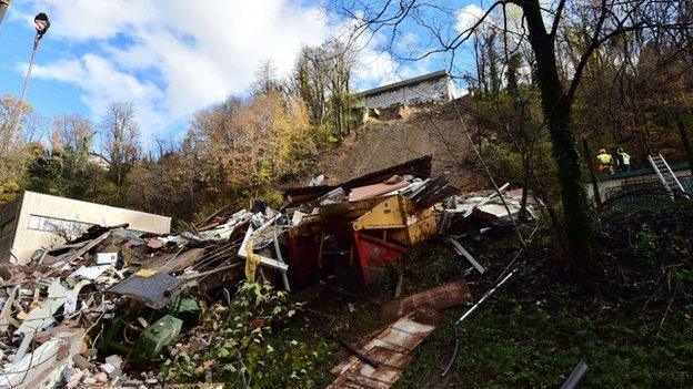 A picture shows the rubbles of a small apartment building after it was hit by a landslide on 16 November 2014 in Switzerland's Ticino region