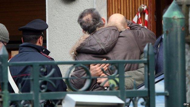 Relatives of the two victims of a landslide comfort one another in Cerro di Laveno, near Varese, northern Italy, on 16 November 2014