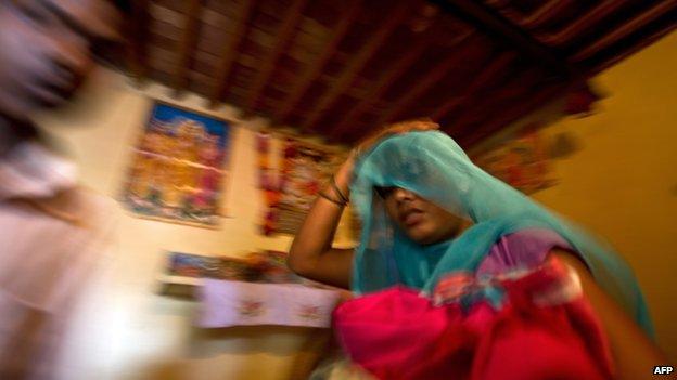 Alleged victim of human trafficking in India, leaving with her belongings after being rescued