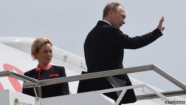 President Vladimir Putin (R) waving goodbye as he leaves the G20 Summit, at the airport in Brisbane