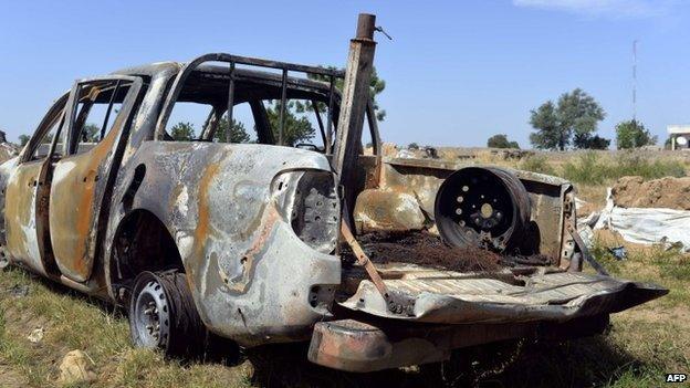 A destroyed vehicle outside a military post in Amchide, Cameroon (15 November 2014)