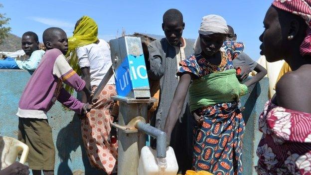 People collect water from a pump on 13 November 2014 in a UNHCR camp for Nigerian refugees in Minawao, in the extreme north-west of Cameroon