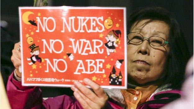 An anti-nuclear power plant demonstrator holds a placard during a protest against restarting Sendai Nuclear Power Plant of Kyushu Electric Power Co. outside the prime minister's official residence in Tokyo, Japan, 07 November 2014