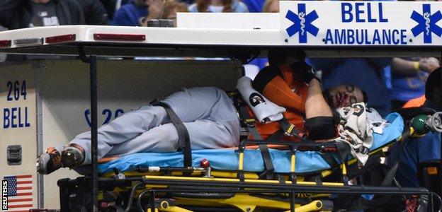 Stanton is carried off on a stretcher after being hit in the face