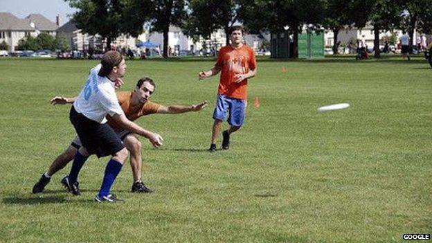 A group of young people playing a game of frisbee