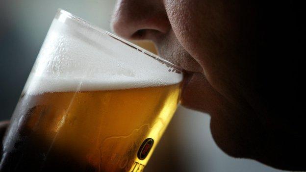 Man drinking pint of lager