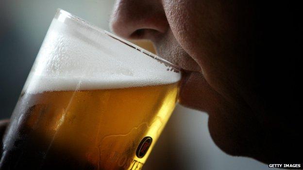 Man drinking pint of lager