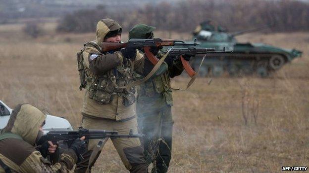 Pro-Russian militants test fire in an open field, in the eastern Ukrainian town of Ilovaisk on 18 November 2014