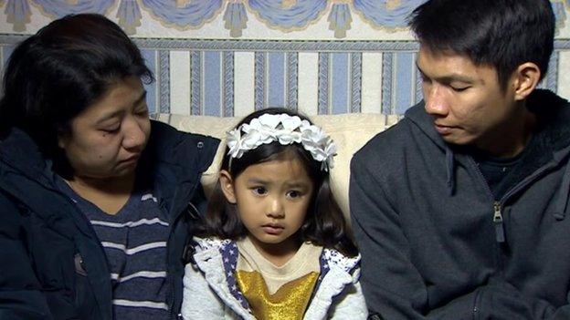 Liberty Sabanal (L) and Jay Sabanal with their daughter Bella