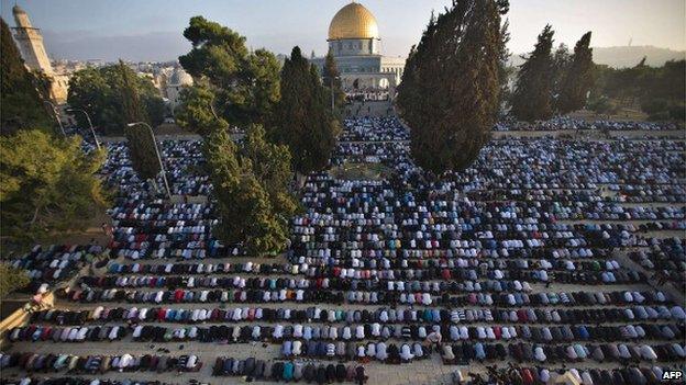 Palestinian Muslims perform the morning Eid Al-Fitr prayer in front of the Dome of Rock at al-Aqsa mosque compound, July 2014