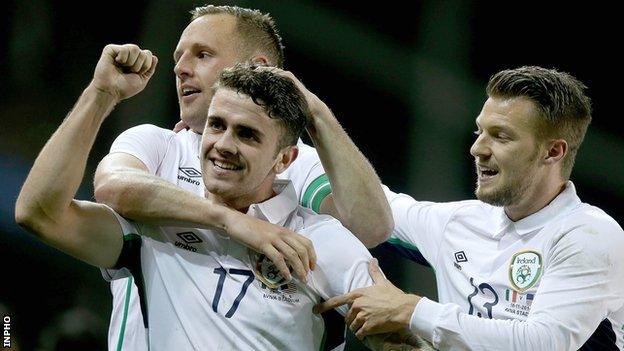 Robbie Brady is congratulated by David Meyler and Anthony Pilkington