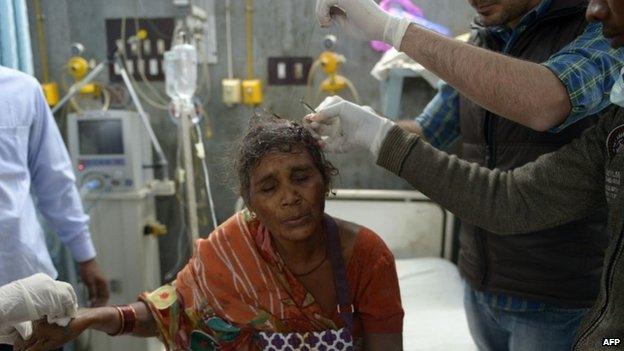 Indian medical staff care for an injured supporter of "Godman" Rampal Maharaj at a hospital in Hisar, some 175 kilometres (108 miles) north of New Delhi on November 18, 2014