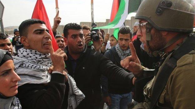 Palestinian protesters confront Israeli soldiers in the West Bank village of Hizma, just northeast of Jerusalem on November 14, 2014