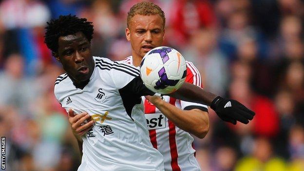 Wilfried Bony takes on Sunderland's Wes Brown