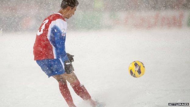 A US football player kicks a ball in the snow against Costa Rica in 2013.