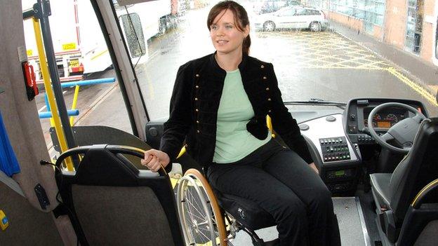 A wheelchair user boards a coach