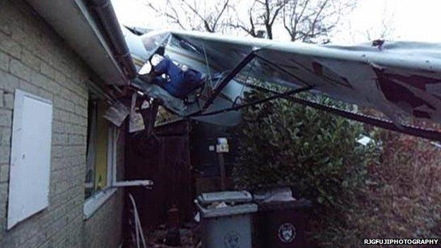 Plane's wing on bungalow roof