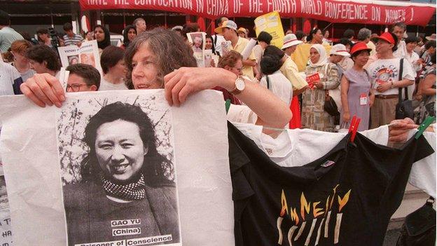 Photo dated 31 August 1995 shows a member of Amnesty International displaying a picture of Chinese prisoner of conscious Gao Yu at a demonstration in Huairou during the Women's NGO Forum.