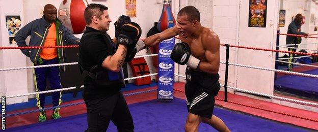 Chris Eubank Jnr in action during a training session at the Brighton and Hove Boxing Club watched by his dad Chris Eubank Snr