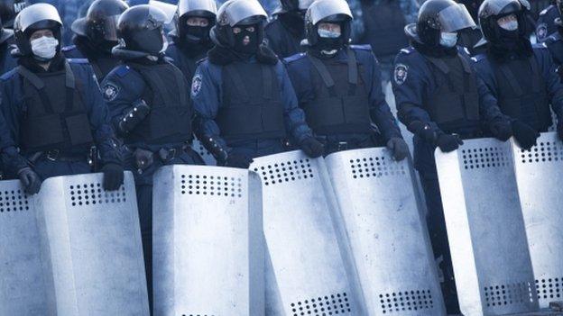 Riot police stand against protesters in Kiev on 24 January 2014