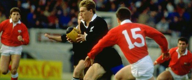 All Blacks wing John Kirwan runs past Wales defenders as Jonathan Davies (left) looks on