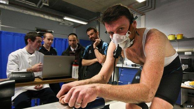 Rob Hayles on exercise bike in oxygen mask