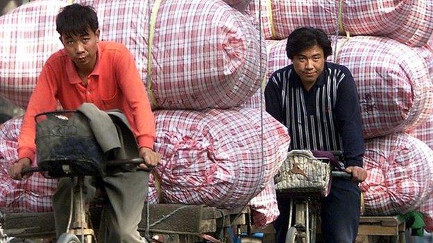 Cyclists with heavy loads in China