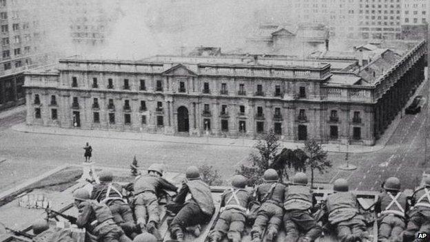 Soldiers supporting the coup led by Gen Augusto Pinochet take cover as bombs are dropped on the Presidential Palace of La Moneda in this 11 September 1973 file photo