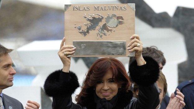 Argentine President Cristina Fernandez de Kirchner holds a plaque before delivering a speech during a ceremony to mark the 30th Anniversary of the 1982 South Atlantic war between Argentina and the Britain over the Falkland Islands