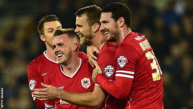 Cardiff players celebrate after Reading player Alex Pearce's own goal