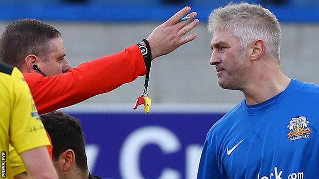 Referee Robert Crangle sends off Glenavon defender William Murphy