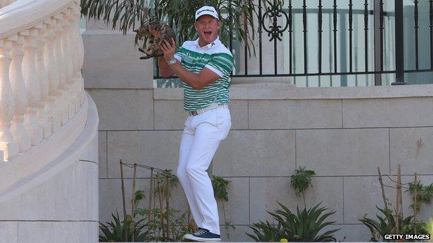 Jamie Donaldson holds the cat aloft