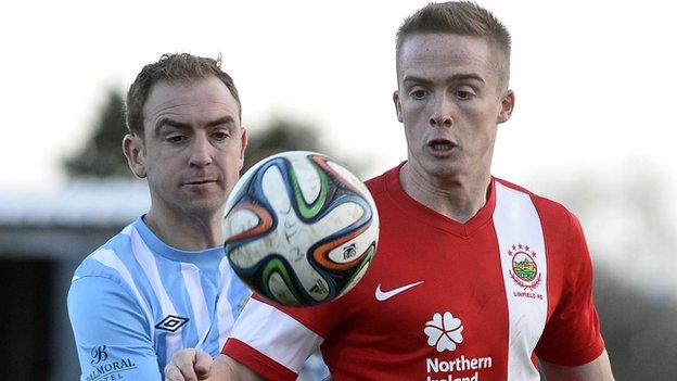 Padraig Smith of Warrenpoint in action against Aaron Burns of Linfield