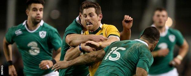 Rob Kearney and Jonathan Sexton combine to tackle Bernard Foley