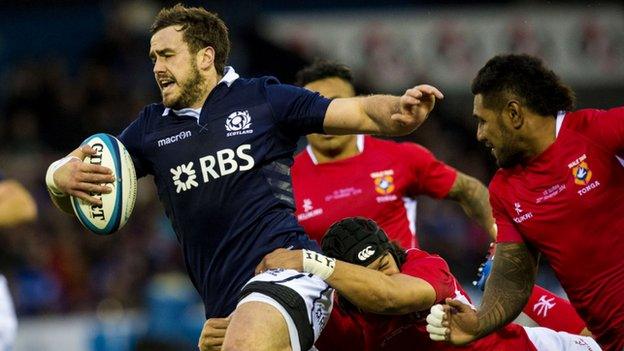 Alex Dunbar is challenged by Tonga's Latiume Fosita (right).