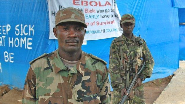 Lt Martin Tejan (left) at an Ebola checkpoint in Sierra Leone, 21 November 2014