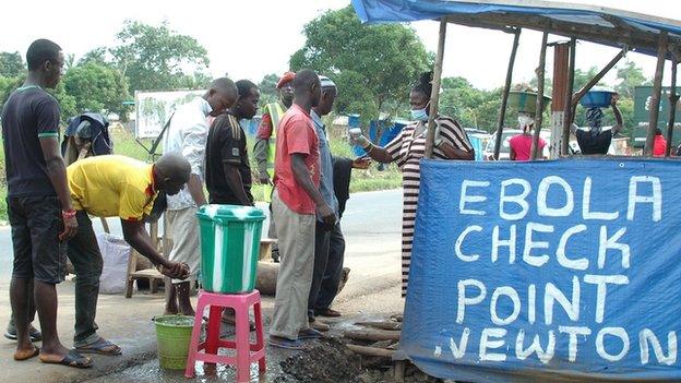 People at an Ebola checkpoint in Sierra Leone, 21 November 2014