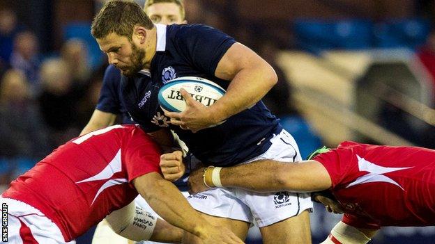 Tonga's Slone Lea (left) and Tukulua Lokotui challenge Ross Ford.