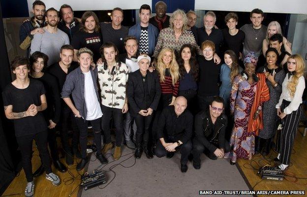 Band Aid 30 artists recording a new version of the song Do They Know It?s Christmas?, to be released in order to raise money for charity, specifically the ebola crisis in west Africa, SARM Studios, Notting Hill, London, UK, 15.11.2014. the group line up.Top Row L-R: Kyle Simmons (Bastille), William Farquarson (Bastille), Guy Garvey (Elbow), Chris "Woody" Wood (Bastille), Chris Martin, Dan Smith (Bastille), Seal, Sir Bob Geldof, Karl Hyde (Underworld), Roger Taylor, Joe Suggs (Thatcher Joe Youtube), Alfie Deyes (Youtube), Milan Neil Amin-Smith (Clean Bandit) and Grace Chatto (Clean Bandit) Second Row L-R Louis Tomlinson, Zayn Malik, Liam Payne, Niall Horan, Harry Styles, Olly Murs, Sinead O"Connor, Ellie Goulding, Jessie Ware, Ed Sheeran, Zoella (Youtube), Angelique Kidjo, Emeli Sande, Paloma Faith.Front Row crouching L-R Midge Ure, Bono