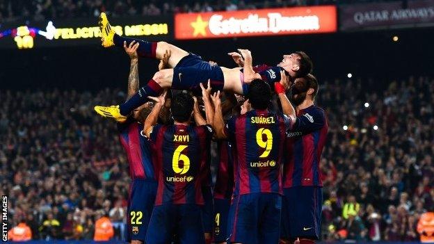 Players carry Lionel Messi on their shoulders