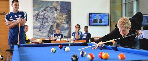 Neil Robertson clears up against John Terry during a visit to Stamford Bridge last year