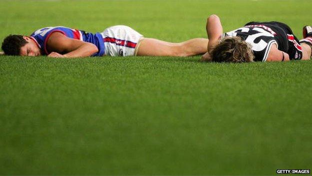 Daniel Giansiracusa of the Bulldogs and Justin Koschitzke of the Saints lie motionless after a shirtfront during the round six AFL match between the St Kilda Saints and the Western Bulldogs at the Telstra Dome 6 May 2006 in Melbourne, Australia.