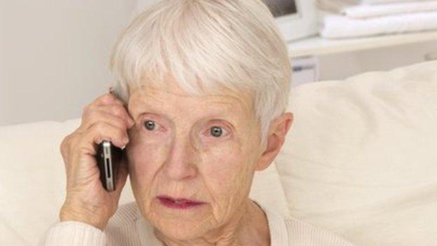 An elderly woman using a phone