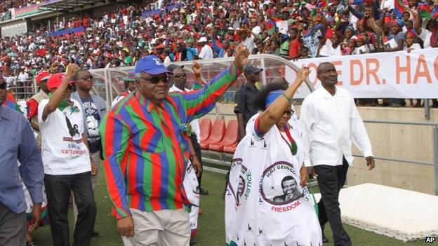 Namibian president Hifikepunye Pohamba, centre left, and his first lady, Penehupifo Pohamba, centre right, arrive at the Sam Nujoma Stadium in Windhoek, Namibia for an election rally