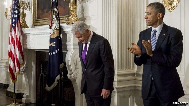 US Secretary of Defence Chuck Hagel bows his head alongside US President Barack Obama after announcing his resignation in the State Dining Room of the White House in Washington in November 2014