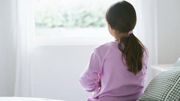 Girl sitting on bed