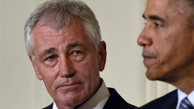 Defence Secretary Chuck Hagel listens as President Barack Obama, talks about Hagel's resignation during an event in the State Dining Room of the White House in Washington on 24 November 2014