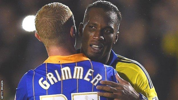 Jack Grimmer shares a hug with Chelsea striker Didier Drogba