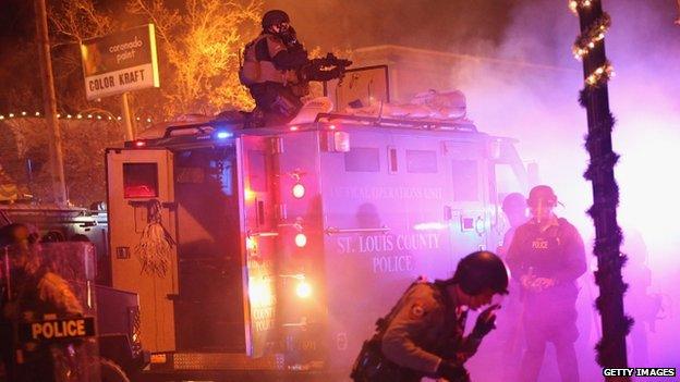 Police confront protestors after rioting broke out following the grand jury announcement in the Michael Brown case on 24 November 2014 in Ferguson, Missouri